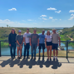 Seven summer students posing for photo overlooking coulee, after group lunch