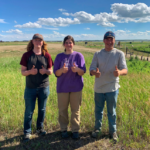 Three summer students posing for photo giving thumbs up