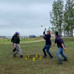 Four summer students playing spike ball during their break